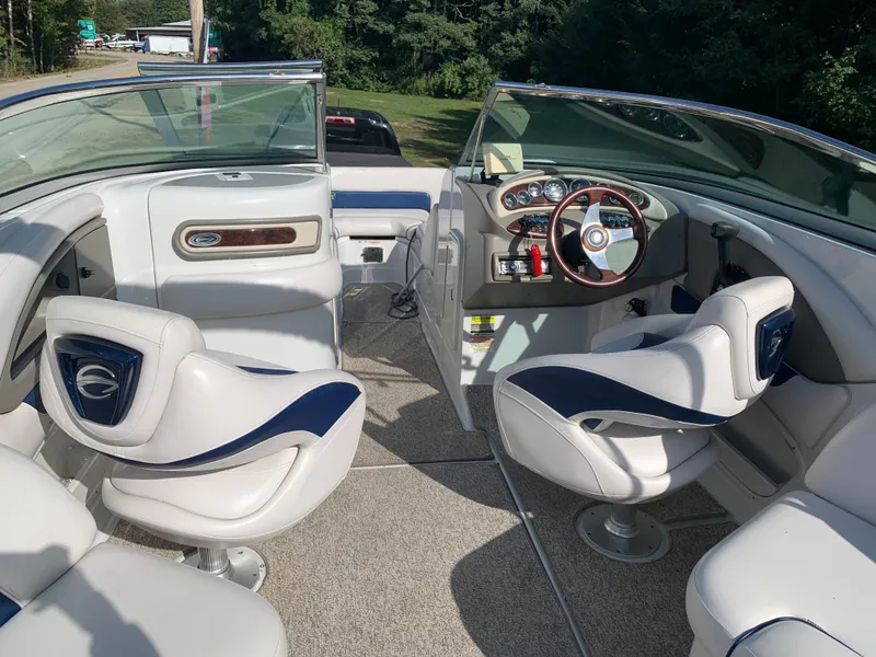 Slide: The Image of Interior of a 2012 Crownline Eclipse E4 boat with white and blue seating. - 13