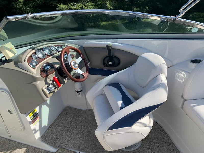 Slide: The Image of 2012 Crownline Eclipse E4 boat cockpit with steering wheel and captain's chair. - 14