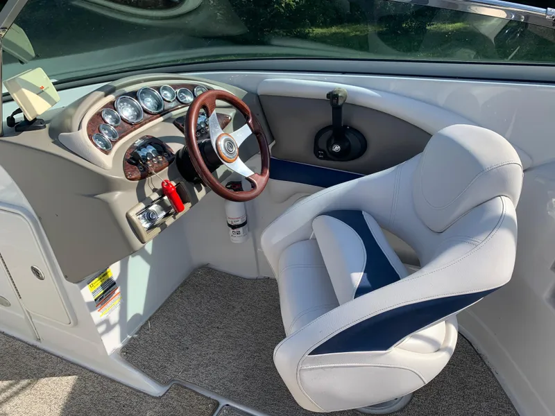 Slide: The Image of 2012 Crownline Eclipse E4 boat cockpit with steering wheel and captain's chair. - 15