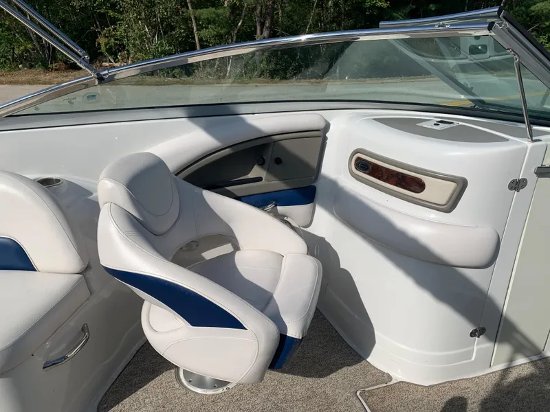 Slide: The Image of Interior of a 2012 Crownline Eclipse E4 boat with white and blue seating. - 18