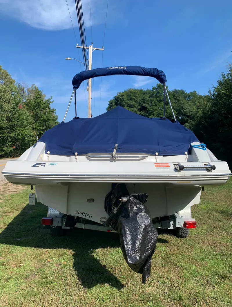 Slide: The Image of 2012 Crownline Eclipse E4 boat with blue cover on a trailer. - 3