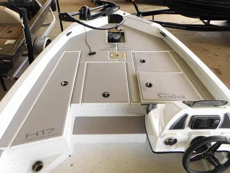Slide: The Image of 2023 Xpress H17 boat deck with SeaDek flooring and storage compartments. - 4