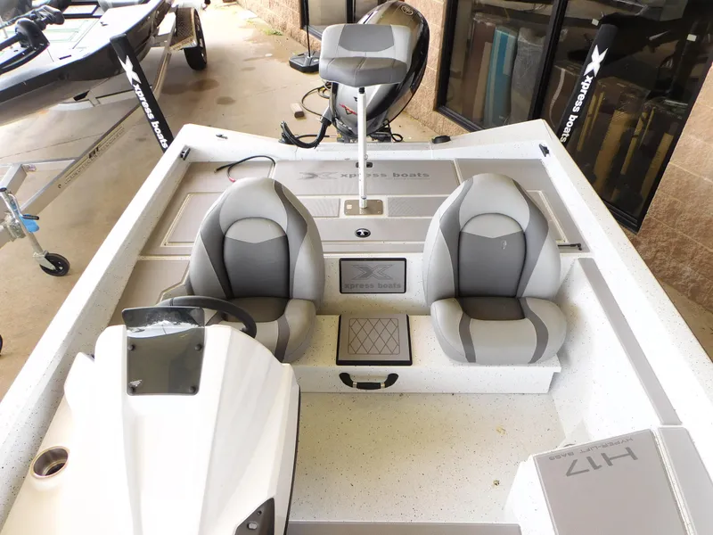 Slide: The Image of 2023 Xpress H17 boat interior with dual seats and steering console. - 5