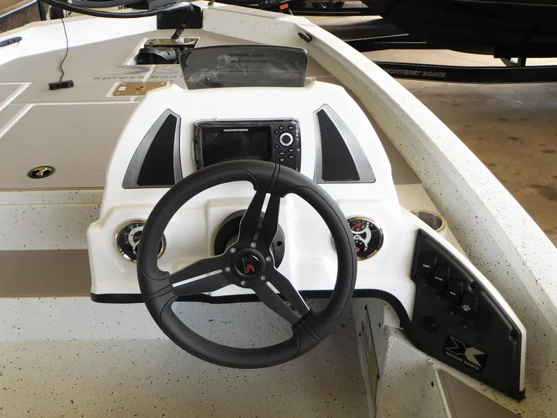 Slide: The Image of 2023 Xpress H17 boat dashboard with steering wheel and control panel. - 6