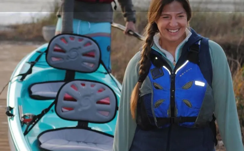 Slide: The Image of Woman with life jacket near Hurricane Kayaks Skimmer 140 Tandem, 2023 model, on a dock. - 6