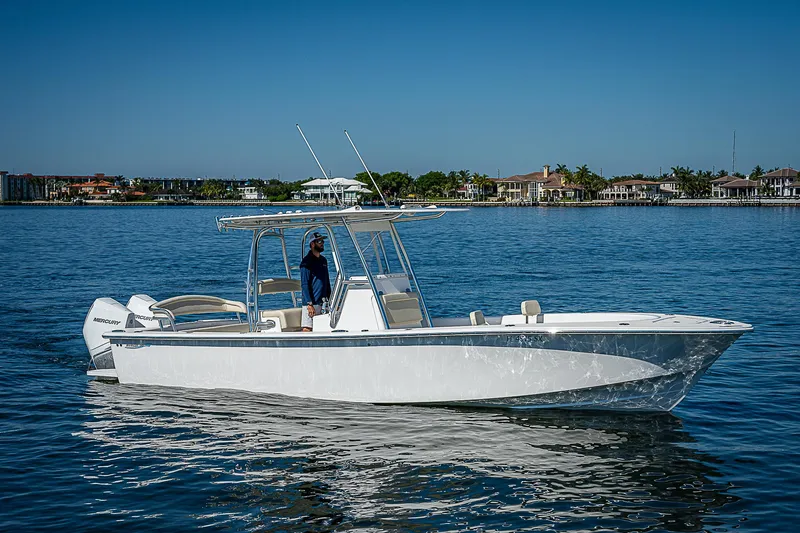 Slide: The Image of 2020 Birdsall 30 CC boat on calm water, clear sky, waterfront homes in background. - 15