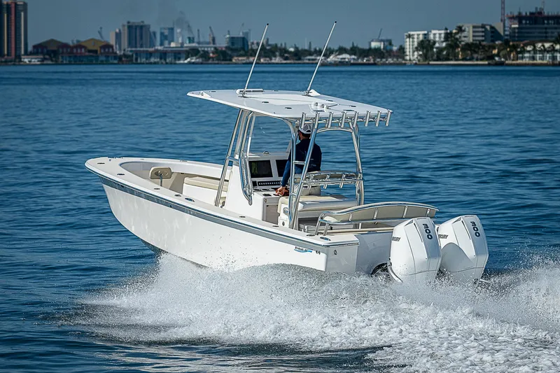 Slide: The Image of 2020 Birdsall 30 CC boat cruising on calm water with city skyline in background. - 18