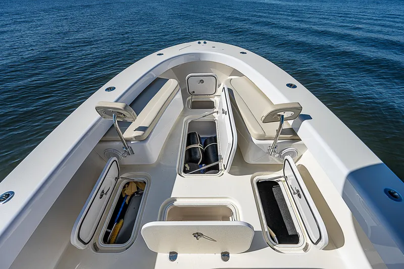 Slide: The Image of 2020 Birdsall 30 CC boat with open storage compartments on calm water. - 23
