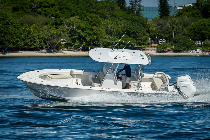 Slide: The Image of 2020 Birdsall 30 CC boat cruising on water near a lush shoreline. - 44
