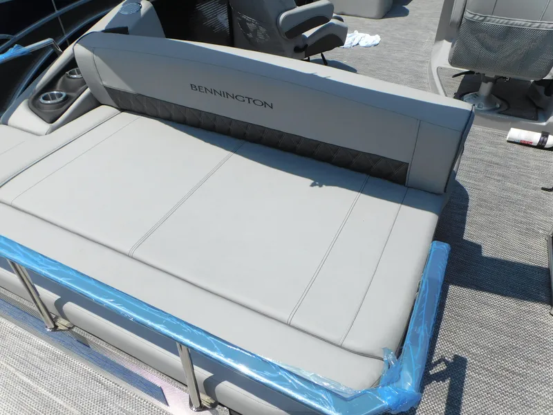 Slide: The Image of 2023 Bennington 24 LXSB boat interior with gray seating and logo. - 4