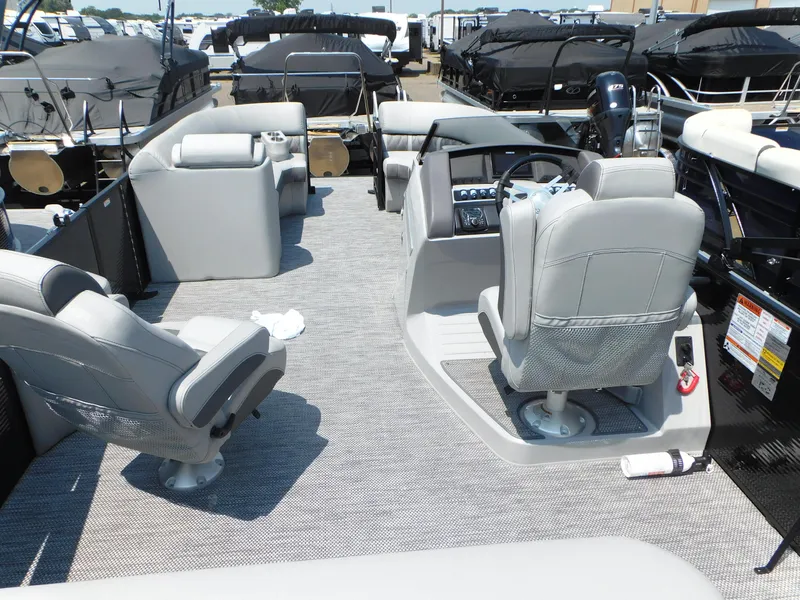 Slide: The Image of 2023 Bennington 24 LXSB pontoon boat interior with gray seating and helm. - 5