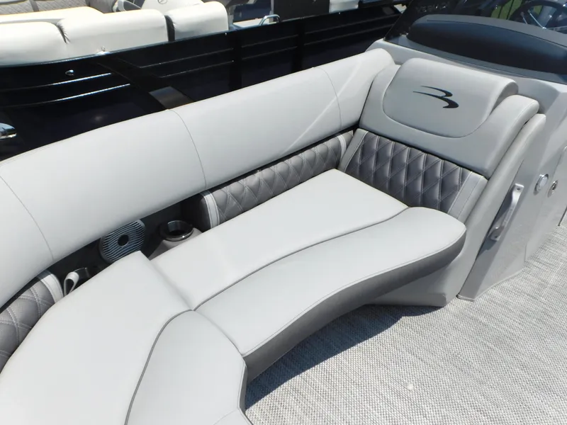 Slide: The Image of 2023 Bennington 24 LXSB boat with luxurious gray seating and quilted accents. - 7