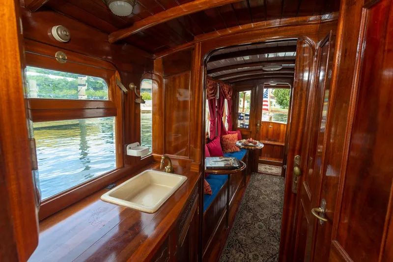 Slide: The Image of Interior of a 1910 Classic Gentleman’s Commuter yacht with wooden finishes and elegant decor. - 11