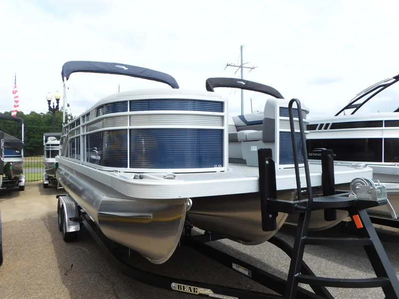 Slide: The Image of 2023 Bennington 22 SX Swingback pontoon boat on trailer. - 0