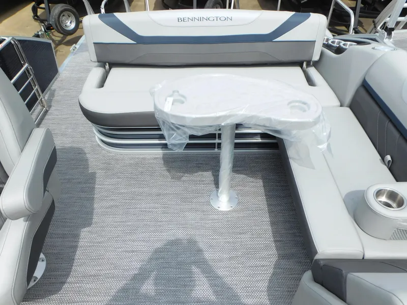 Slide: The Image of 2023 Bennington 22 SX Swingback boat interior with seating and table. - 5