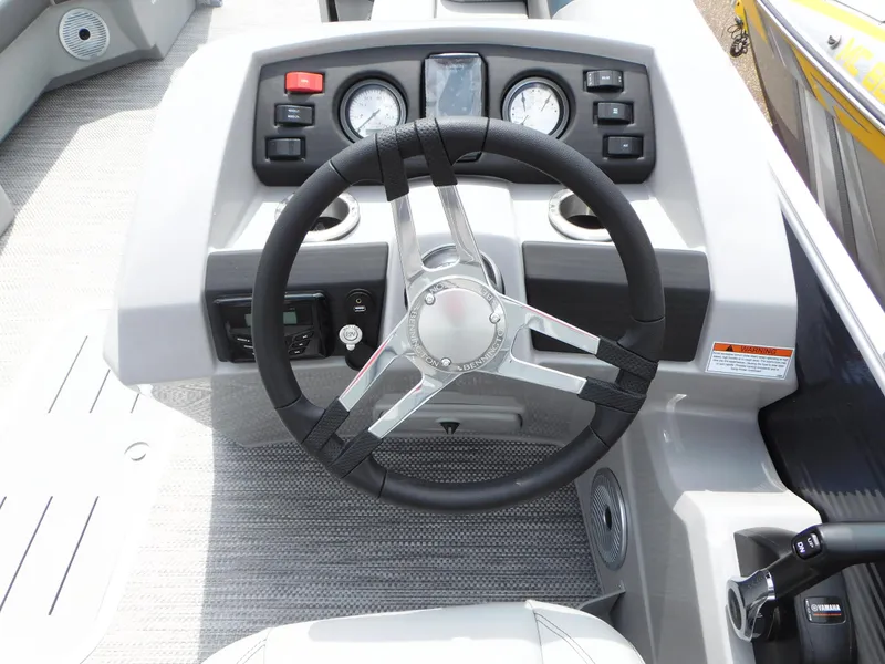 Slide: The Image of 2023 Bennington 22 SX Swingback boat steering console with gauges and controls. - 7