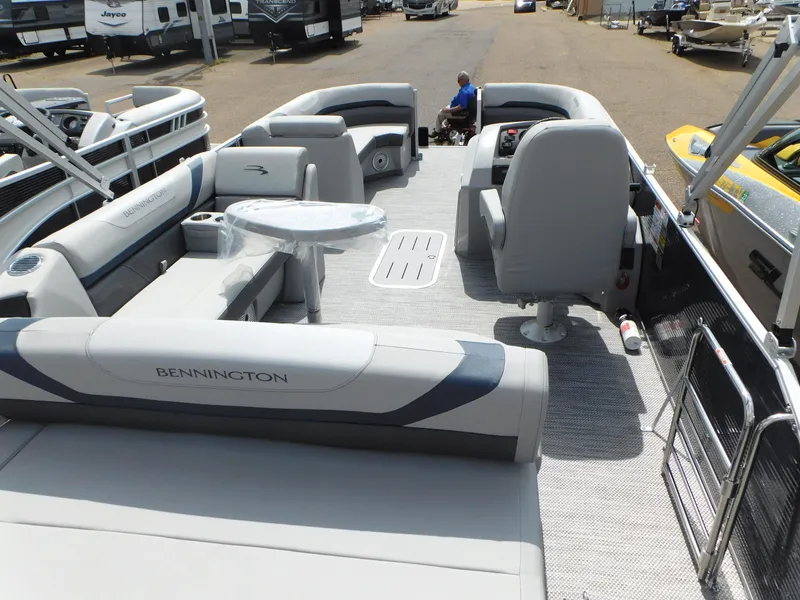 Slide: The Image of 2023 Bennington 22 SX Swingback pontoon boat interior with seating and table. - 8
