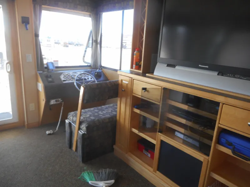 Slide: The Image of Interior of 2005 Twin Anchors Caspian share #9 houseboat with helm, TV, and storage cabinets. - 19