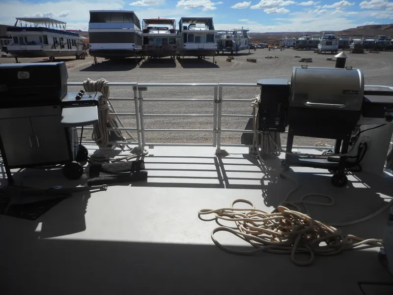 Slide: The Image of Deck view of 2005 Twin Anchors Caspian share #9 houseboat with grills and ropes. - 21