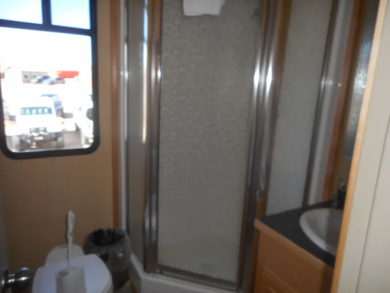 Slide: The Image of 2005 Twin Anchors Caspian Share #9 bathroom with shower, sink, and window. - 8