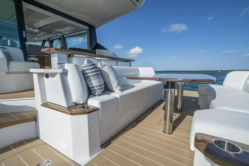 Slide: The Image of 2025 Tiara Yachts EX60 luxury yacht deck with seating and ocean view. - 10