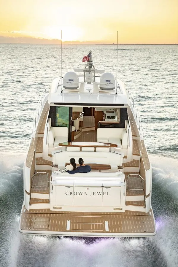 Slide: The Image of 2025 Tiara Yachts EX60 cruising at sunset with passengers on deck. - 12