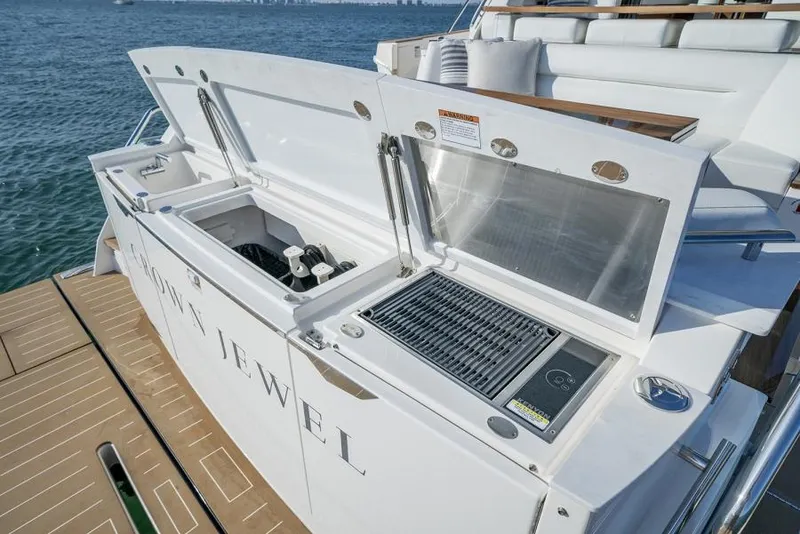 Slide: The Image of Outdoor kitchen on 2025 Tiara Yachts EX60, featuring grill and storage compartments. - 14