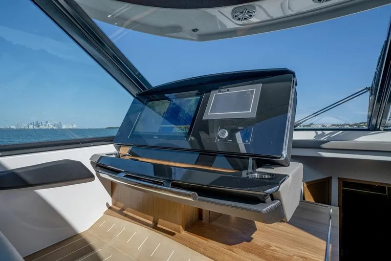 Slide: The Image of 2025 Tiara Yachts EX60 helm station with advanced navigation system. - 19