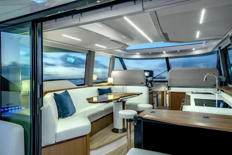 Slide: The Image of Luxurious interior of 2025 Tiara Yachts EX60 with modern seating and panoramic windows. - 21