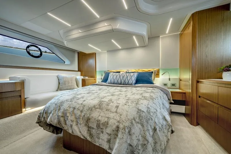 Slide: The Image of Luxurious bedroom in 2025 Tiara Yachts EX60 with modern design and ambient lighting. - 25