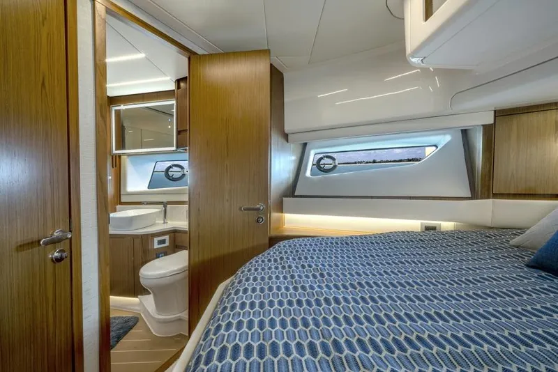 Slide: The Image of 2025 Tiara Yachts EX60 bedroom with ensuite bathroom and modern interior design. - 29