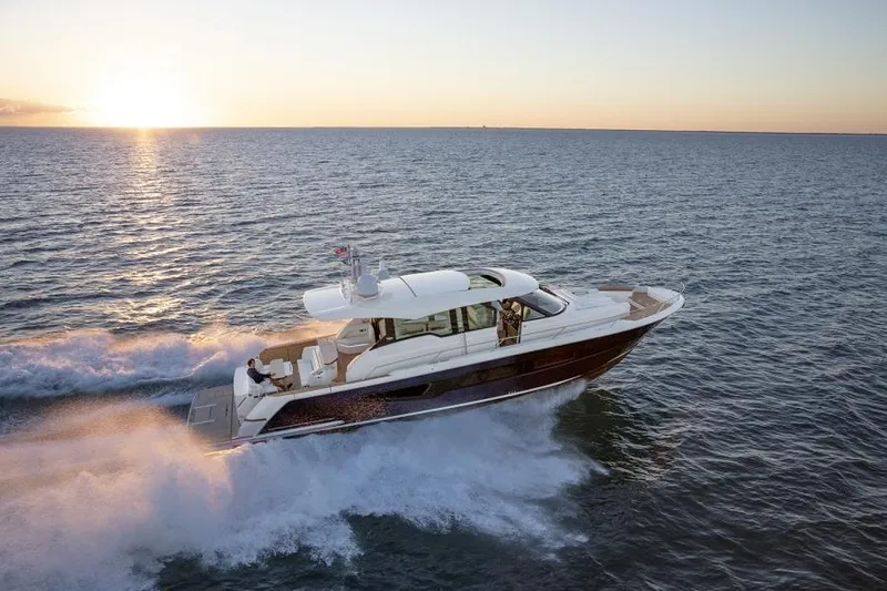 Slide: The Image of 2025 Tiara Yachts EX60 cruising at sunset on open water. - 4