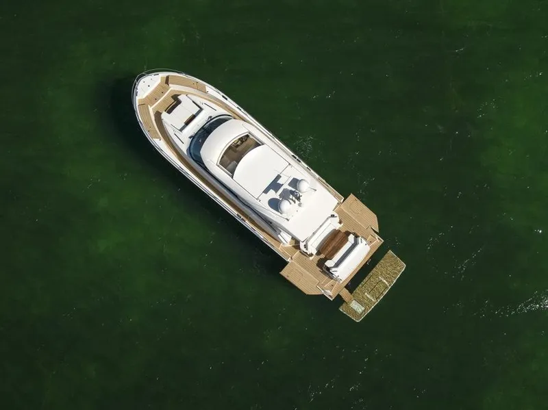 Slide: The Image of Aerial view of 2025 Tiara Yachts EX60 luxury yacht on green water. - 5