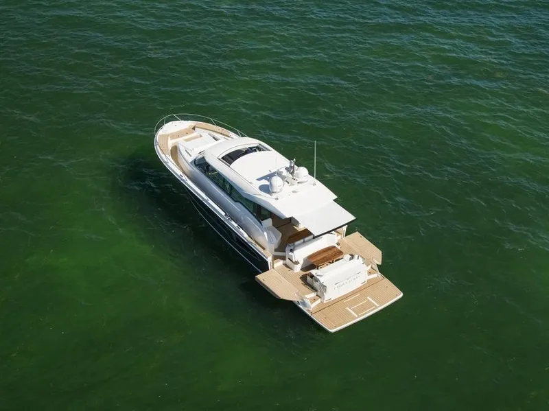 Slide: The Image of 2025 Tiara Yachts EX60 luxury yacht cruising on open water. - 8