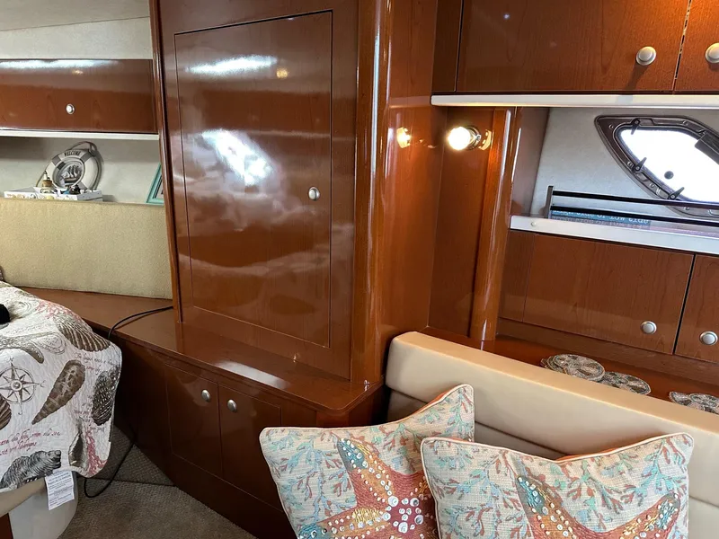 Slide: The Image of Interior of a 2008 Sea Ray 330 Sundancer yacht with wooden cabinetry and decorative pillows. - 23
