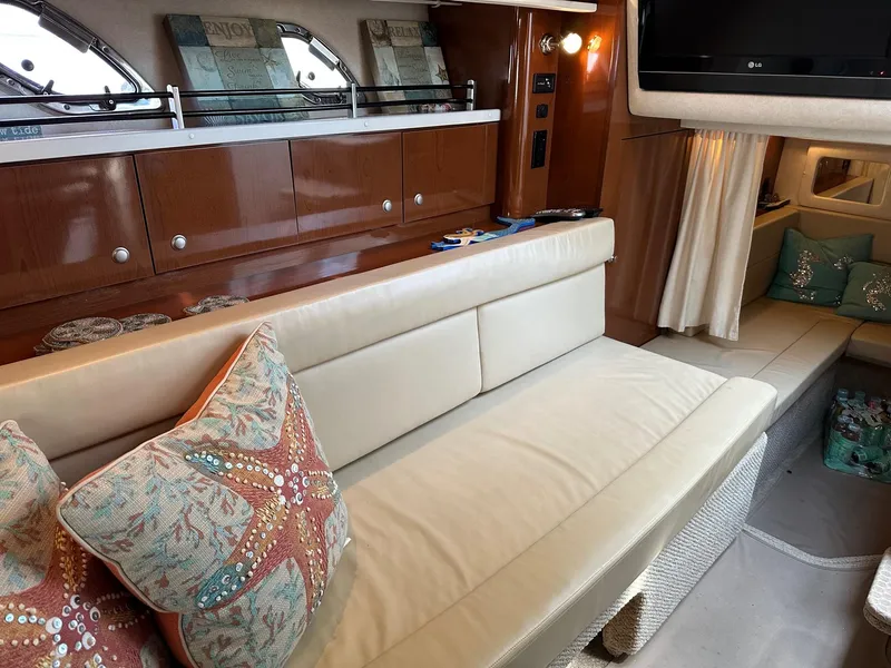 Slide: The Image of Interior of a 2008 Sea Ray 330 Sundancer with beige leather seating and starfish-themed pillows. - 24