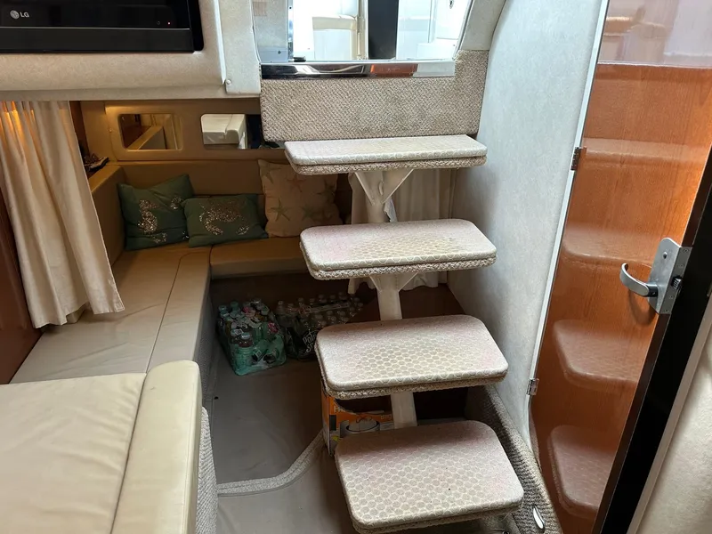 Slide: The Image of Interior of 2008 Sea Ray 330 Sundancer with stairs, seating area, and storage. - 26