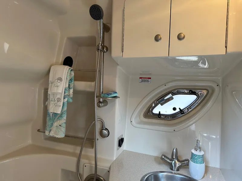 Slide: The Image of Sea Ray 330 Sundancer 2008 bathroom with shower, sink, and porthole window. - 27