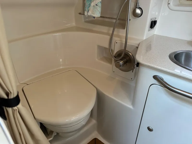 Slide: The Image of 2008 Sea Ray 330 Sundancer bathroom with toilet, sink, and shower. - 28