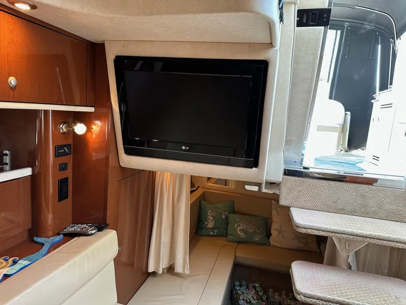 Slide: The Image of 2008 Sea Ray 330 Sundancer interior with TV, seating, and cabin view. - 30