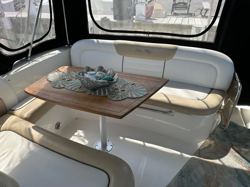 Slide: The Image of Interior seating area of a 2008 Sea Ray 330 Sundancer with a wooden table. - 8