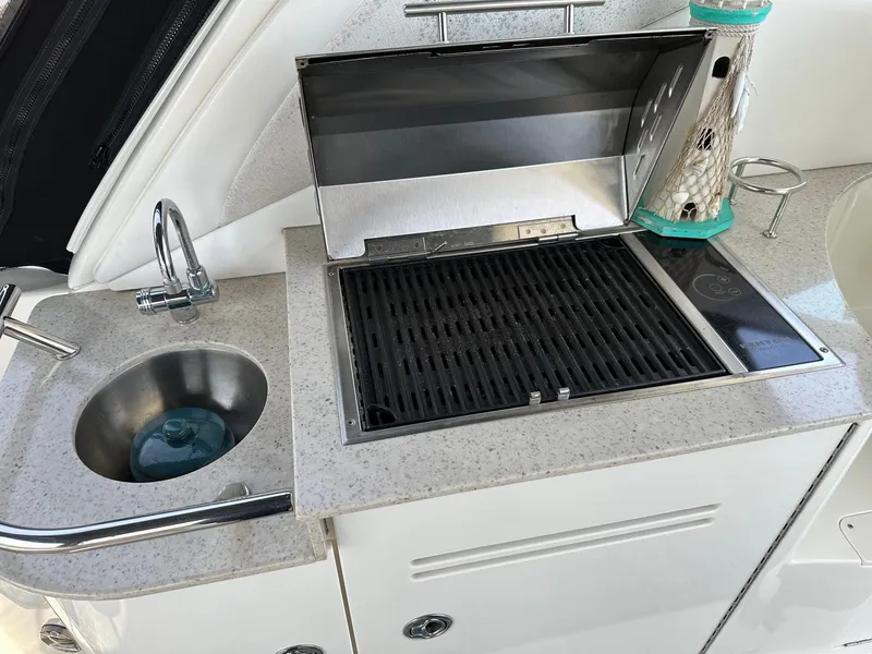 Slide: The Image of Outdoor kitchenette on a 2008 Sea Ray 330 Sundancer with sink and grill. - 9