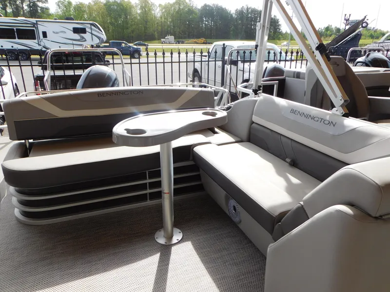 Slide: The Image of 2023 Bennington 22SX Swingback pontoon boat interior with seating and table. - 2