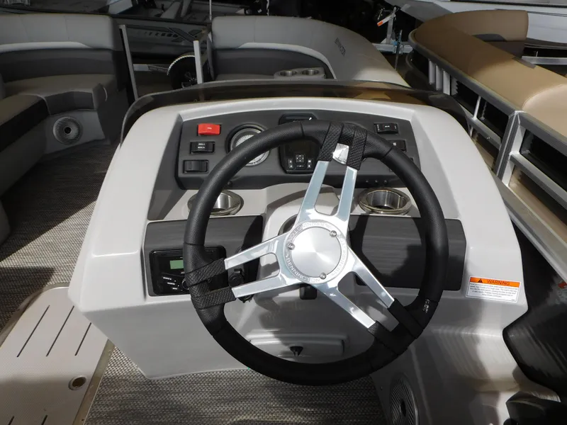 Slide: The Image of 2023 Bennington 22SX SWINGBACK boat dashboard with steering wheel and controls. - 3