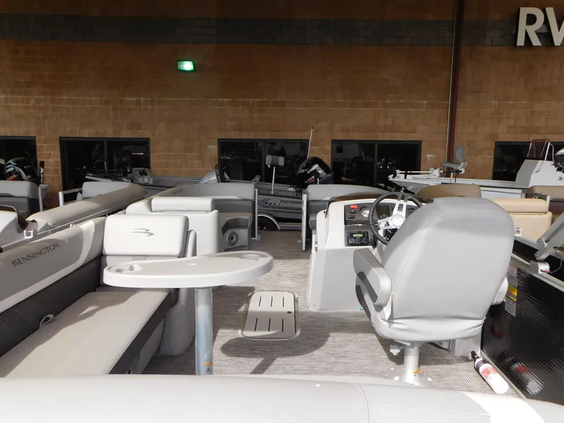 Slide: The Image of 2023 Bennington 22SX SWINGBACK pontoon boat interior with seating and helm. - 6