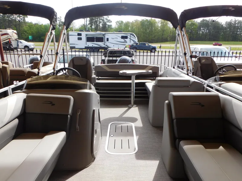 Slide: The Image of 2023 Bennington 22SX SWINGBACK pontoon boat interior with seating and table. - 8