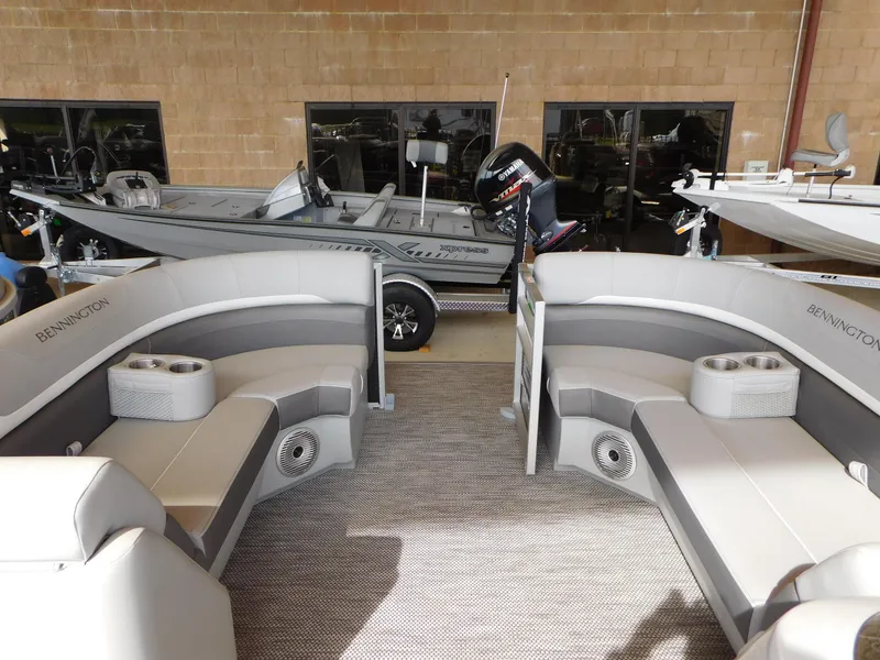 Slide: The Image of 2023 Bennington 22SX Swingback pontoon boat interior with plush seating and cup holders. - 9