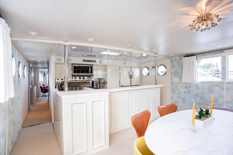 Slide: The Image of Luxurious 1966 Burger Classic yacht bedroom with elegant decor and cozy seating area. - 15