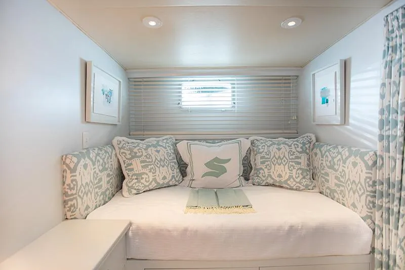 Slide: The Image of Twin beds with floral bedding in a classic 1966 Burger yacht cabin. - 24