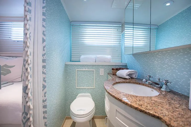 Slide: The Image of Compact bathroom with light blue walls, modern fixtures, and a small window. - 26